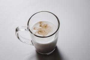 clear glass mug with white liquid